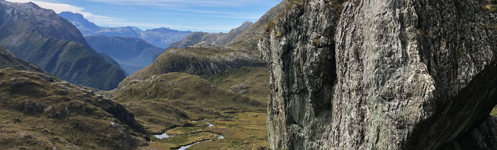 Rock outcrop overlooking an alpine valley on the Routeburn Track, New Zealand