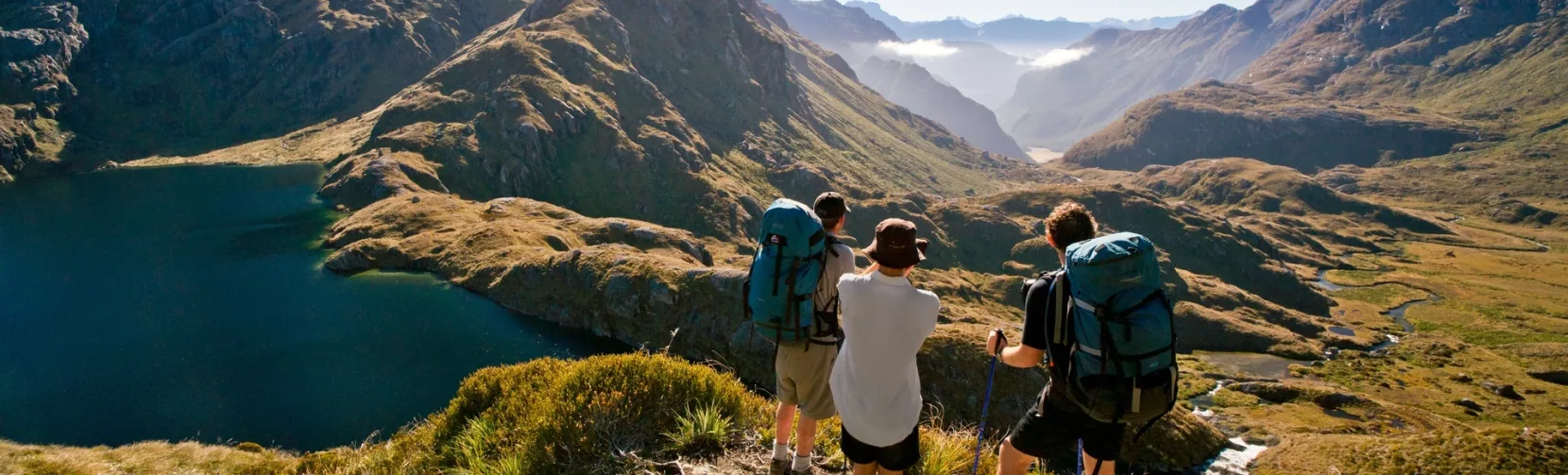 Hikers overlooking Lake Harris on the Routeburn Track