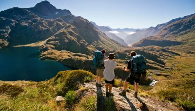 Hikers overlooking Lake Harris on the Routeburn Track