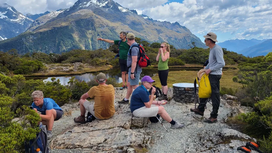 Guided group resting at Key Summit on the Routeburn Track
