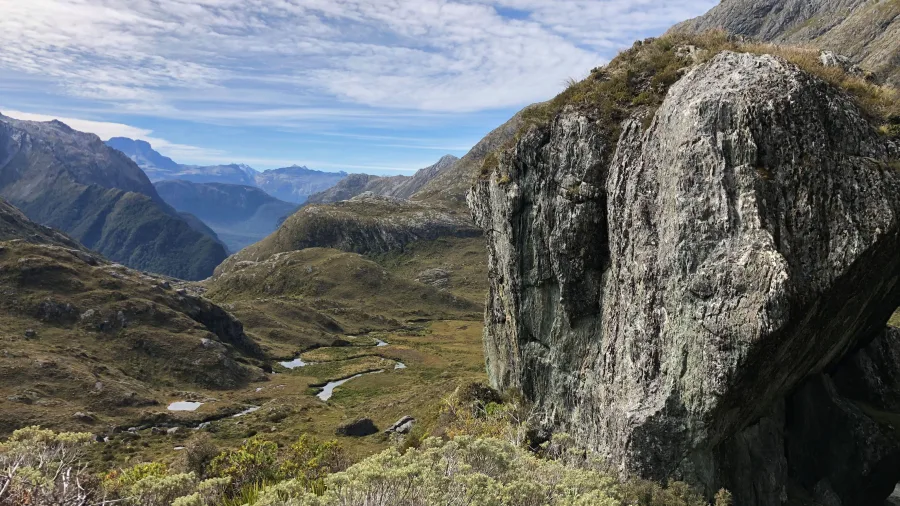Rock outcrop overlooking an alpine valley on the Routeburn Track, New Zealand