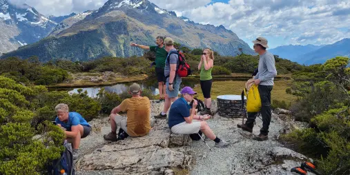 Guided group resting at Key Summit on the Routeburn Track