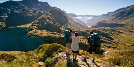 Hikers overlooking Lake Harris on the Routeburn Track