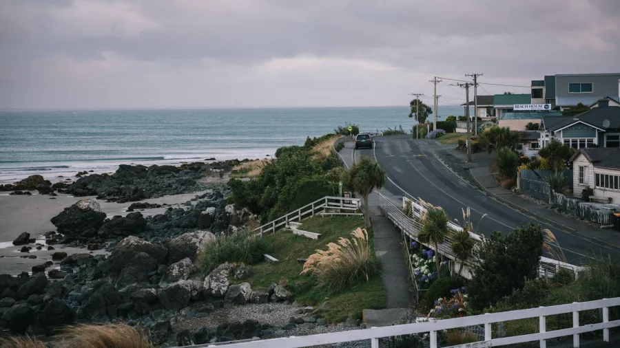Coastal road winding through Riverton with ocean views and rocky shoreline