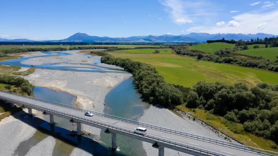 Vehicles crossing a bridge over the Oreti River in Lumsden, Southland