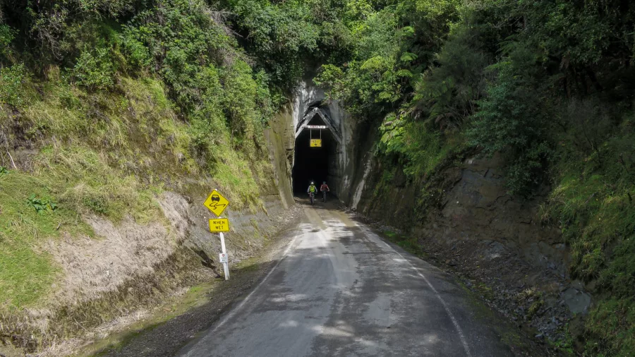 Cyclists emerging from the Moki Tunnel on the Forgotten World Highway in New Zealand