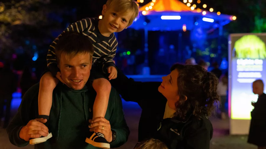 Smiling family enjoying colourful lights at the TSB Festival of Lights in New Plymouth