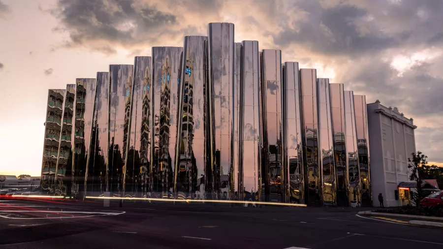 Sunset reflection on the mirrored façade of Len Lye Centre in New Plymouth