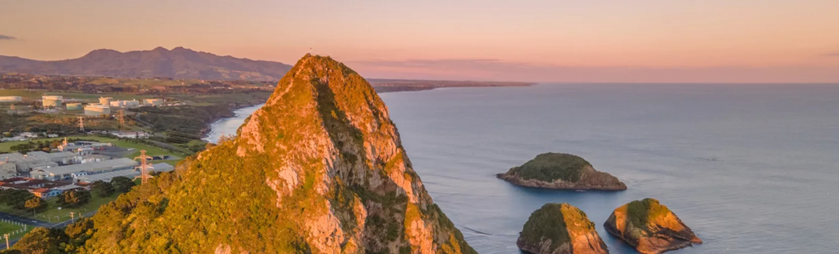 Aerial view of Paritutu Rock and Sugar Loaf Islands at sunrise in New Plymouth: Credit Skyview Photography