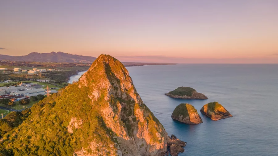 Aerial view of Paritutu Rock and Sugar Loaf Islands at sunrise in New Plymouth: Credit Skyview Photography