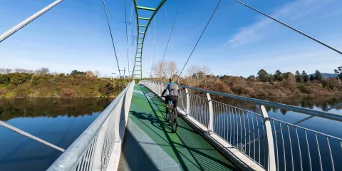 Cyclist crossing Perry Bridge in Horotiu on the Te Awa River Ride near Hamilton