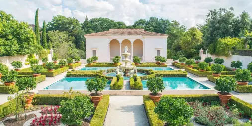 Aerial view of the Italian Renaissance Garden at Hamilton Gardens showing symmetrical pools, potted citrus trees, and formal landscaping in New Zealand