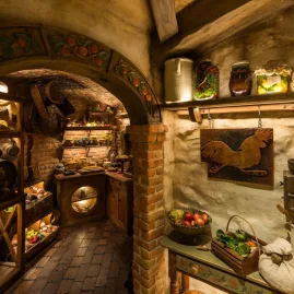 Hobbit kitchen and pantry inside Bagshot Row with shelves of food props and wooden décor