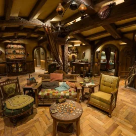 Interior of a Hobbit hole in Bagshot Row with rustic wooden furniture and warm lighting