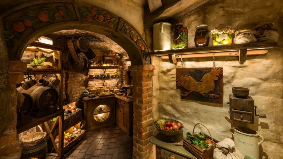 Hobbit kitchen and pantry inside Bagshot Row with shelves of food props and wooden décor