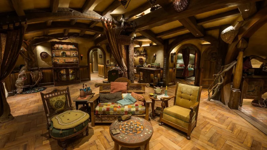 Interior of a Hobbit hole in Bagshot Row with rustic wooden furniture and warm lighting
