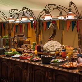 Buffet table with rustic dishes and decorations at Hobbiton Evening Banquet Feast
