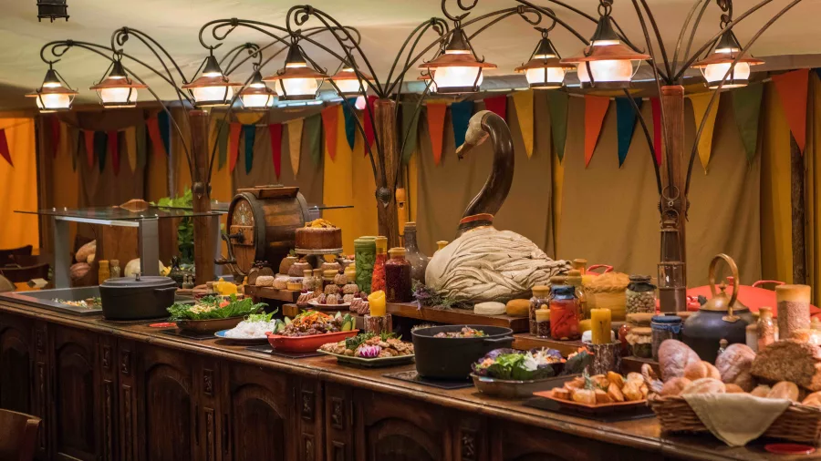 Buffet table with rustic dishes and decorations at Hobbiton Evening Banquet Feast