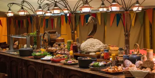 Buffet table with rustic dishes and decorations at Hobbiton Evening Banquet Feast