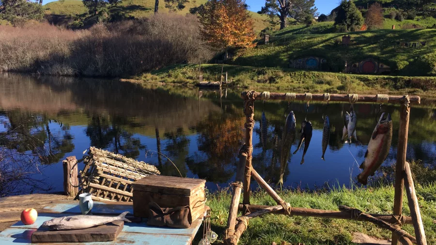 Rustic fishing props by the lake with Hobbit Holes in the background