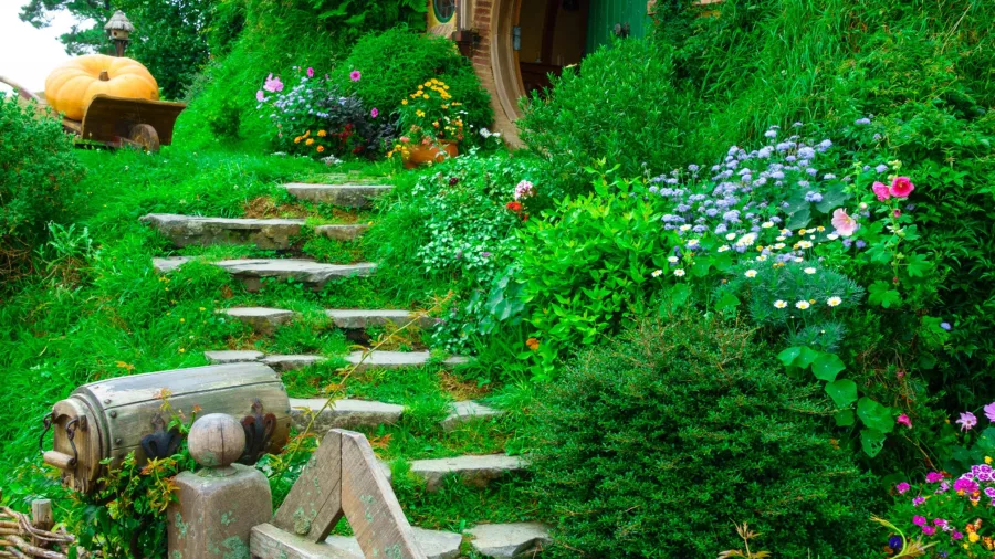 Steps leading up to Bag End, the hobbit home of Bilbo and Frodo Baggins, surrounded by lush gardens at Hobbiton Movie Set