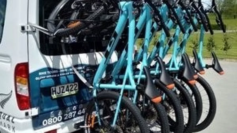 Blue bikes mounted on a shuttle van operated by Riverside Adventures
