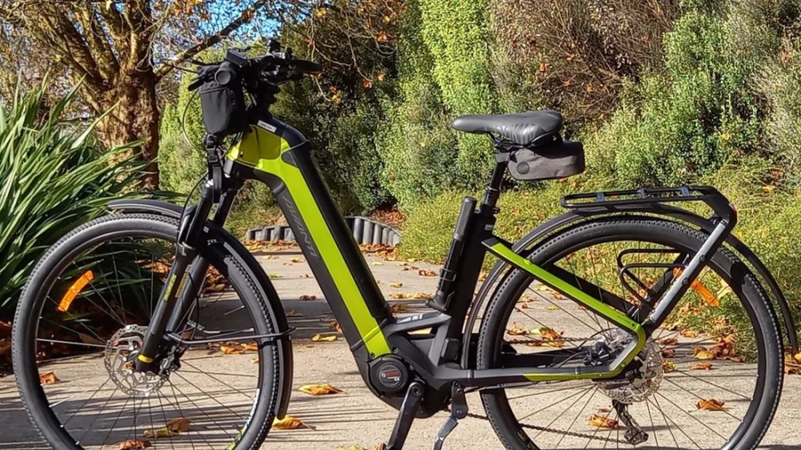 Electric bike parked on a leafy trail with autumn trees and greenery