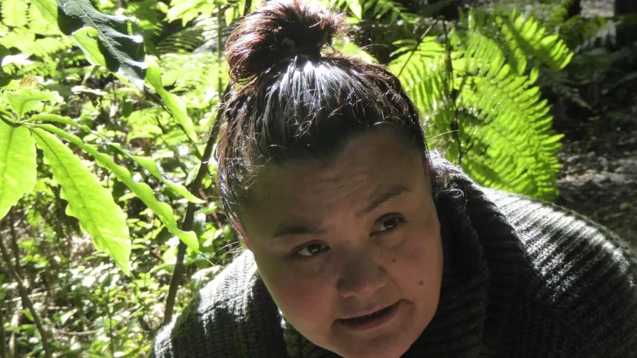Close-up of Jamie Hiriaki speaking during a rongoā forest tour