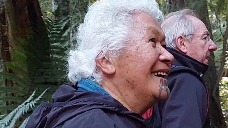 Wahine Māori smiling during a Rongoā Rākau walk in the native forest