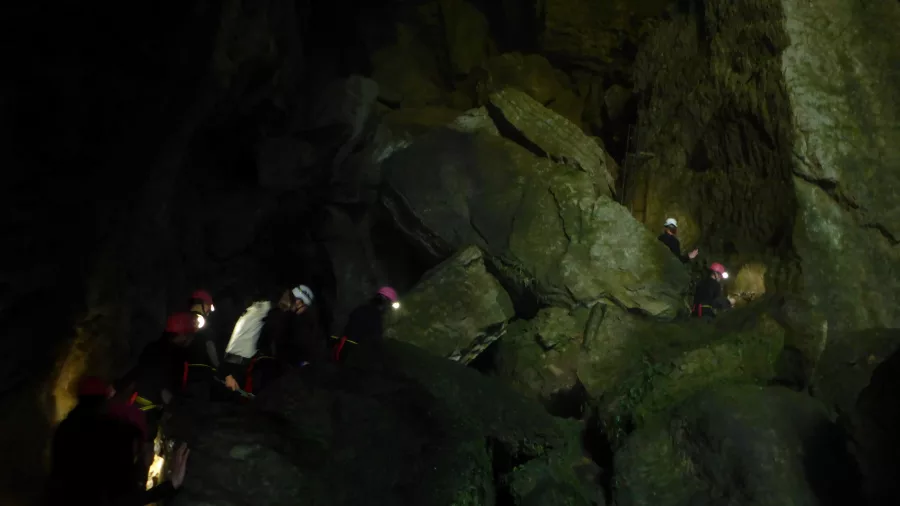 Underground boulder climb inside limestone cave in Waikato