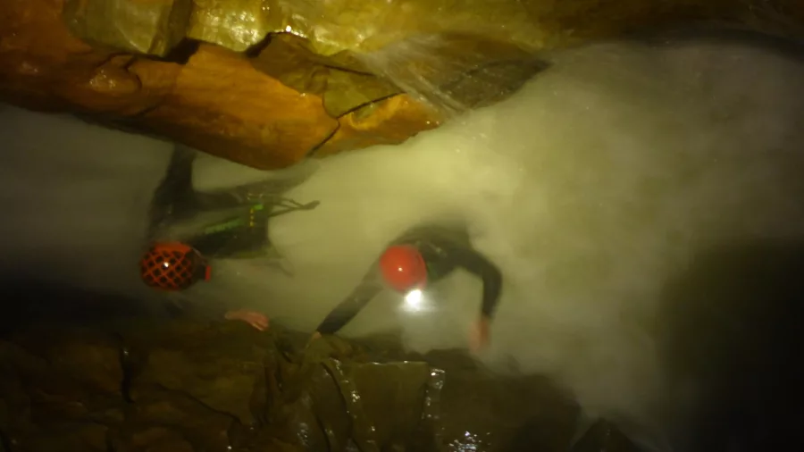 Underground waterfall crawl cave adventure in New Zealand