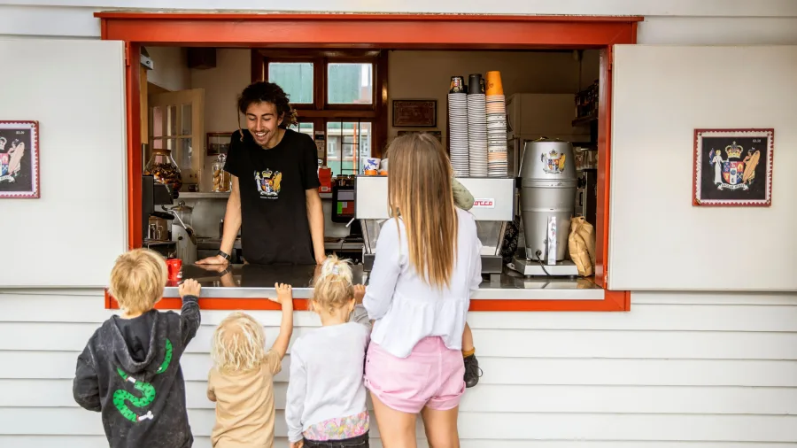 Family with children ordering drinks at Raglan Roast coffee in Waikato.