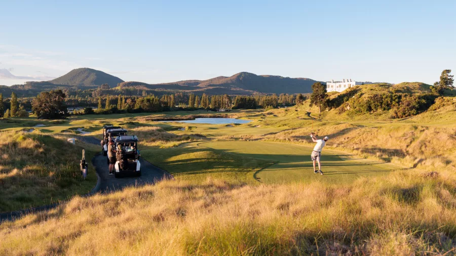 Golfer teeing off at Kinloch Golf Club’s Jack Nicklaus-designed championship course in Taupō, New Zealand.