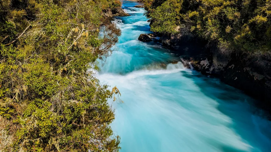 Turquoise water surging through the narrow channel at Huka Falls in Wairakei, Taupō, New Zealand.