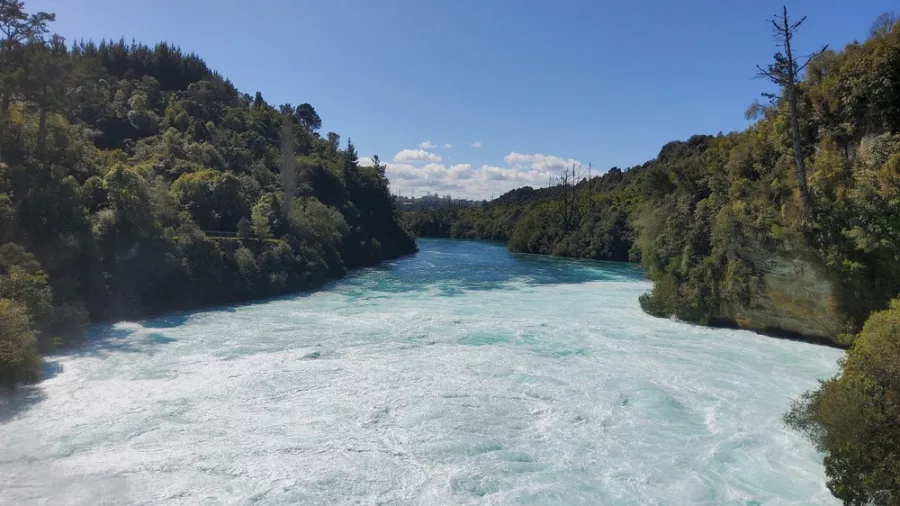 Huka Falls powerful water rushing through a forested gorge on the Waikato River near Lake Taupō, New Zealand
