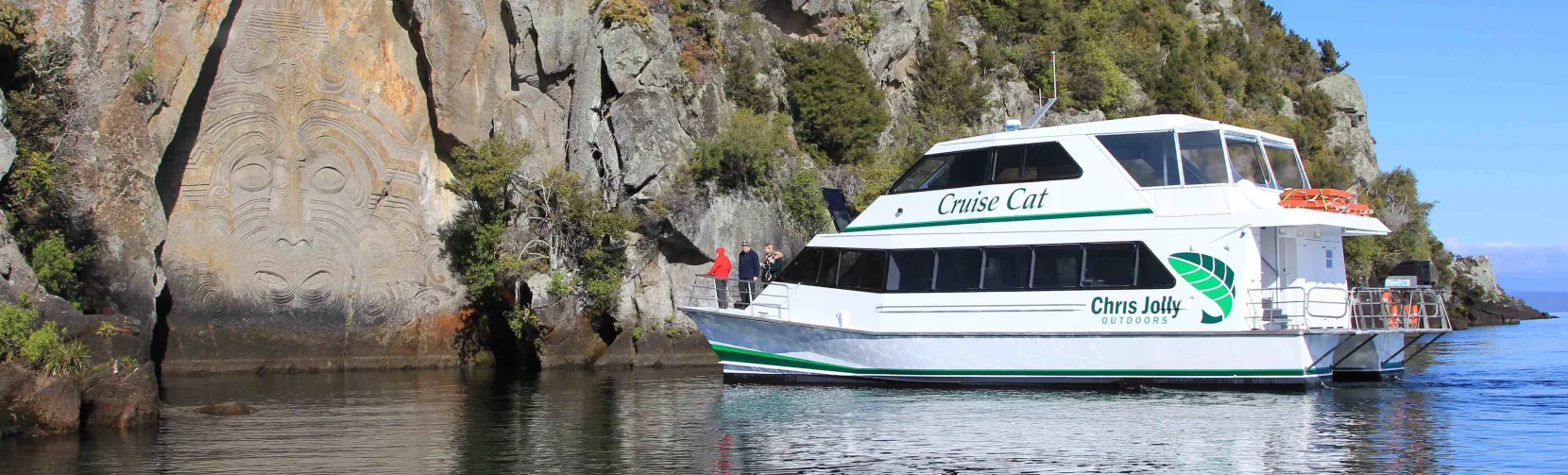 Chris Jolly Outdoors' Cruise Cat viewing the Māori Rock Carvings on Lake Taupō