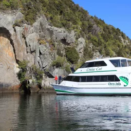 Chris Jolly Outdoors' Cruise Cat viewing the Māori Rock Carvings on Lake Taupō