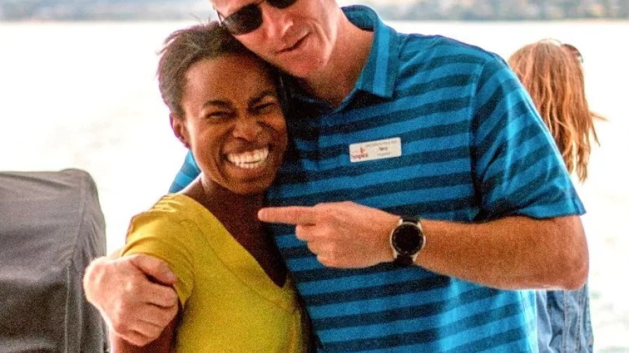 Smiling guest posing with crew member aboard Lake Taupō scenic cruise