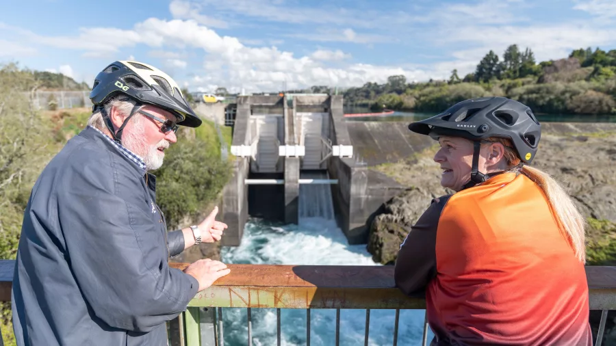 Two cyclists at the viewing platform overlooking Aratiatia Dam