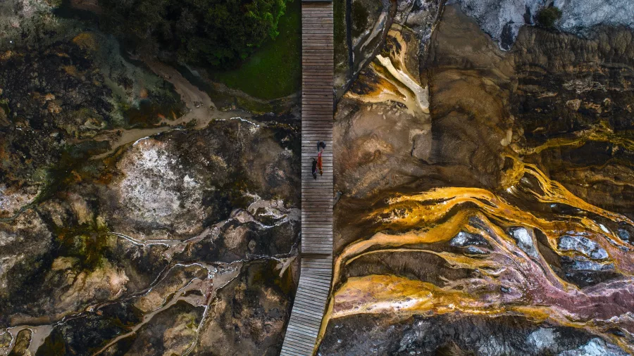 Boardwalk crossing over colourful geothermal terraces at Orakei Korako