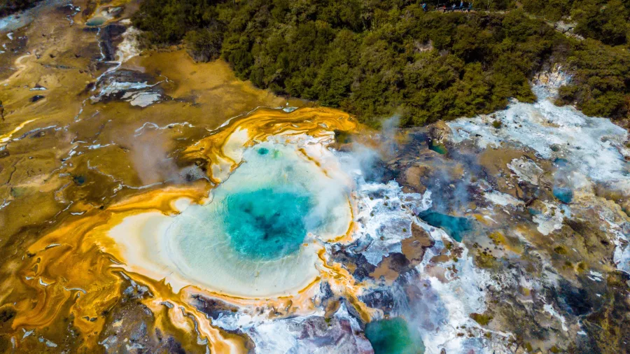 Colourful geothermal pools and silica terraces at Ōrākei Kōrako seen from above