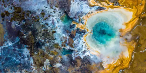 Geothermal pool with blue water and golden silica terraces at Orakei Korako