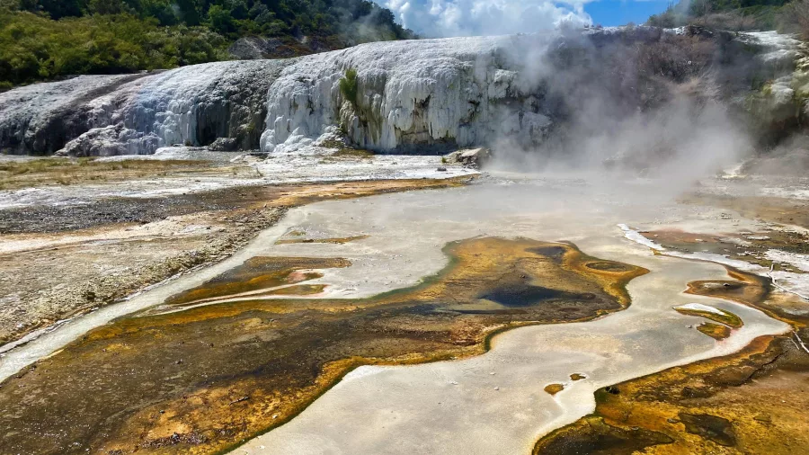 Geothermal stream and silica formations with steam rising at Orakei Korako