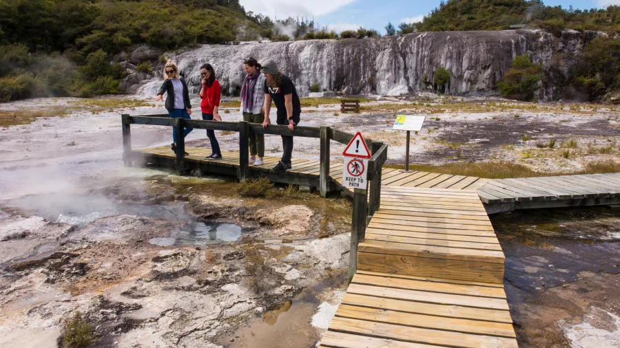 Group observing geothermal features on a guided walk at Orakei Korako