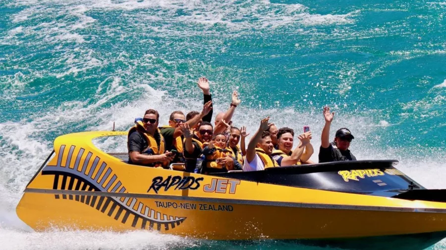 Rapids Jet boat navigating the fast-moving Waikato River surrounded by forest near Taupō, New Zealand.