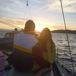 Couple watching the sunset aboard the Kindred Spirit yacht on Lake Taupō
