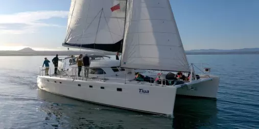 Tiua catamaran sailing Lake Taupō with guests enjoying a bright morning cruise