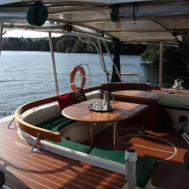 Cockpit seating and dining area on Tiua yacht overlooking Lake Taupō