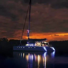Tiua yacht illuminated on Lake Taupō at dusk after a sunset cruise