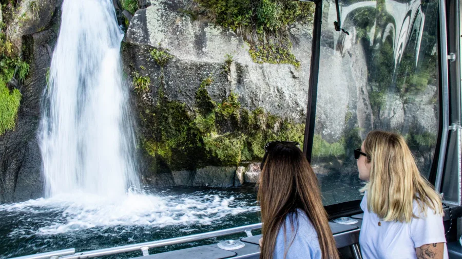 Two women viewing Otupoto Falls from the Venture Beyond boat on Lake Taupō